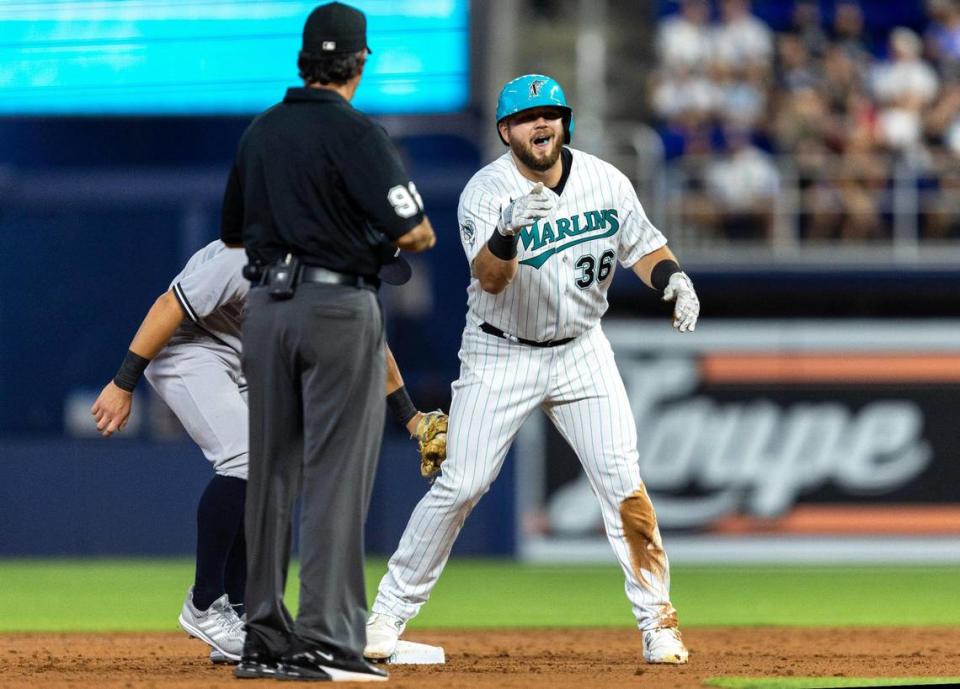 Miami Marlins base runner Jake Burger (36) reacts to hitting a double to score a run during the second inning of an MLB game against the New York Yankees at loanDepot park in the Little Havana neighborhood of Miami, Florida, on Friday, August 11, 2023.