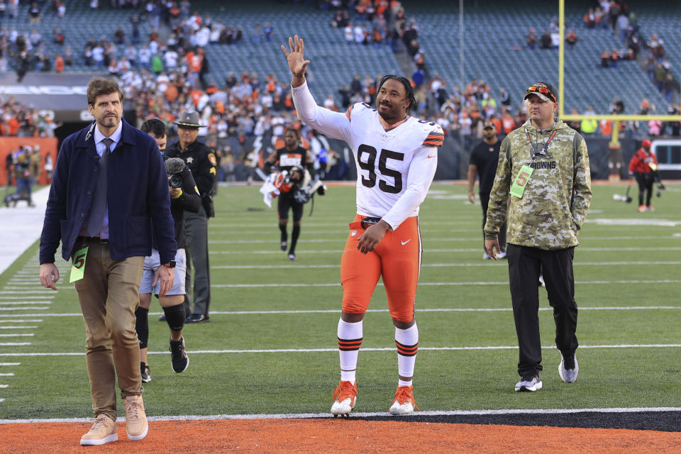 Cleveland Browns' Myles Garrett (95) waves to fans as he leaves the field following an NFL football game against the Cleveland Browns, Sunday, Nov. 7, 2021, in Cincinnati. (AP Photo/Aaron Doster)