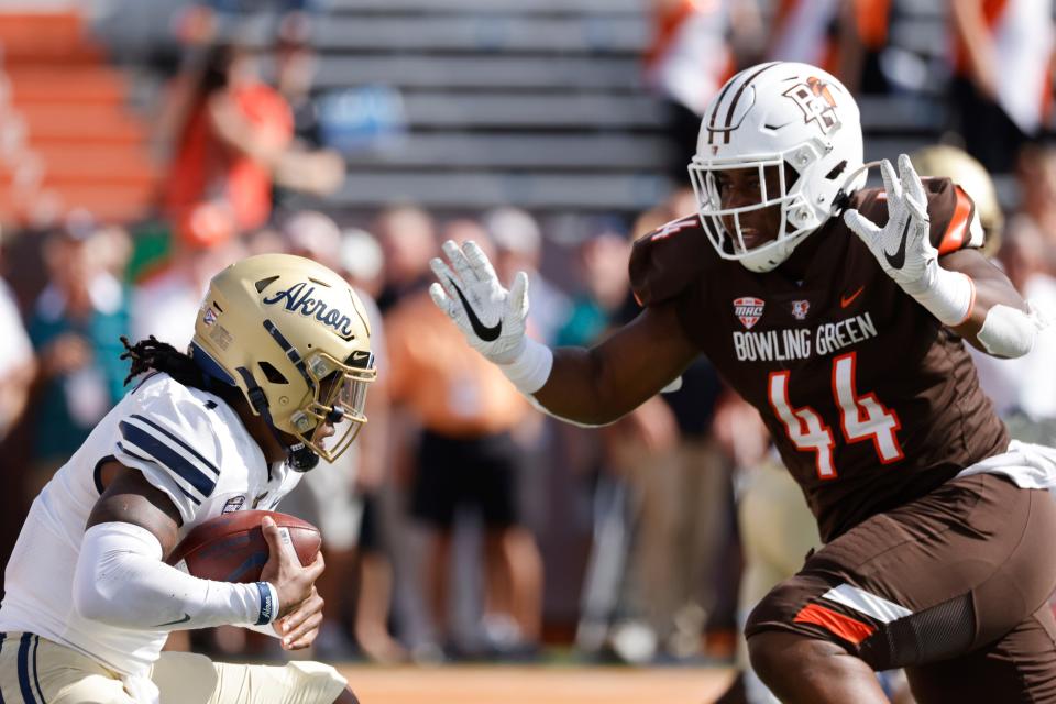 Bowling Green defensive lineman Karl Brooks (44) rushes on defense at Akron quarterback Kato Nelson (1) in the first half during an NCAA football game on Saturday, Oct. 9, 2021, in Bowling Green, Ohio. (AP Photo/Rick Osentoski)