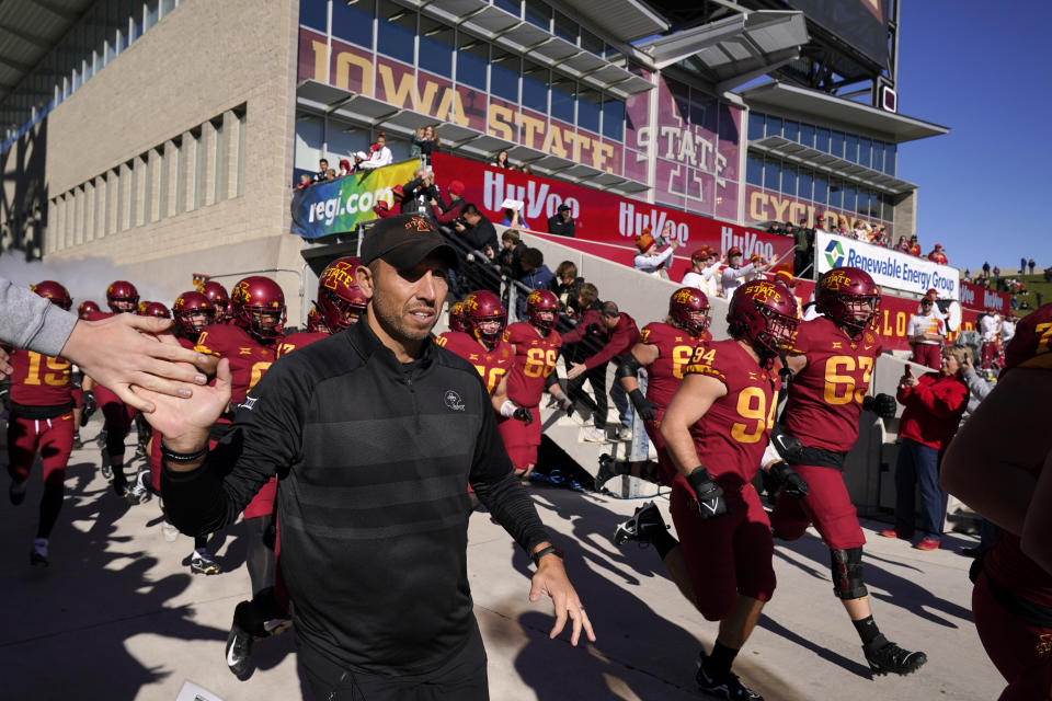 Iowa State head coach Matt Campbell runs onto the field before an NCAA college football game against West Virginia, Saturday, Nov. 5, 2022, in Ames, Iowa. College athletic programs of all sizes are reacting to inflation the same way as everyone else. They're looking for ways to save. Travel and food are the primary areas with increased costs. (AP Photo/Charlie Neibergall)