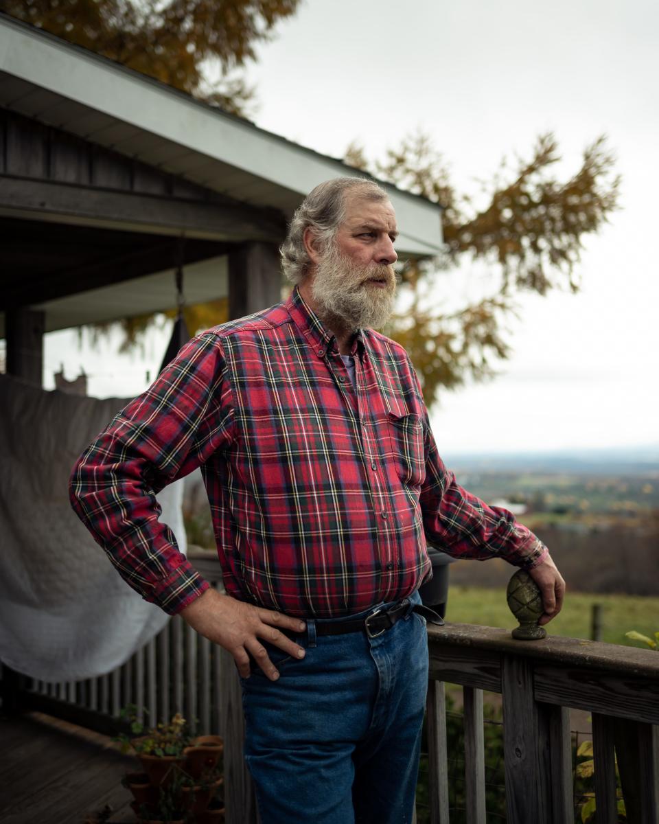 Ben Simons stands out on the back porch of his home with his farmland in the background atop of Starr Hill in Remsen, NY. He was approached by a land agent interested in leasing acres of Simons’ land to build an array of solar panels to convert the sun’s energy into electricity and deliver it to the state’s electrical grid.