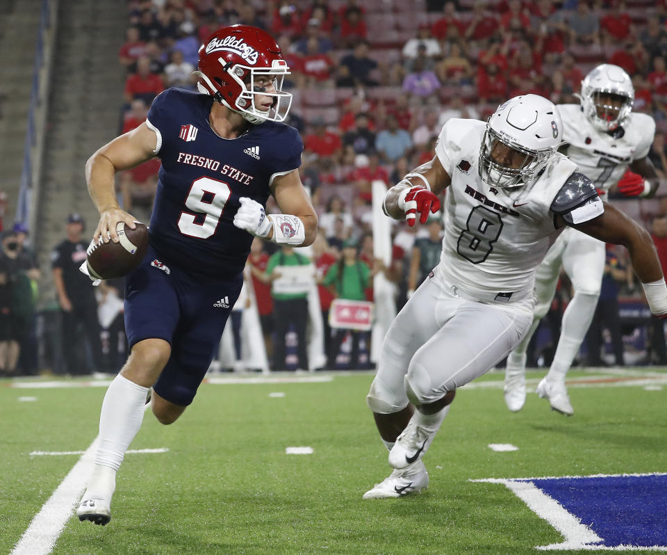 Fresno State quarterback Jake Haener avoids a sack against UNLV linebacker Kylan Wilborn during the first half of an NCAA college football game in Fresno, Calif., Friday, Sept. 24, 2021. (AP Photo/Gary Kazanjian)