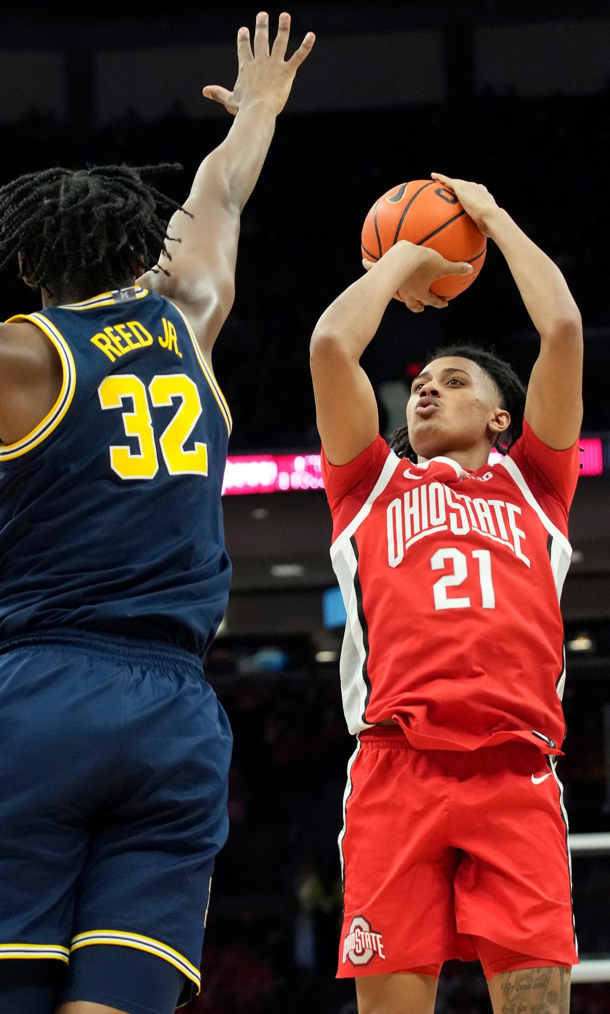 Mar 3, 2024; Columbus, OH, USA; Ohio State Buckeyes forward Devin Royal (21) shoots guarded by Michigan Wolverines forward Tarris Reed Jr. (32) during their NCAA Division I Mens basketball game at Value City Arena.