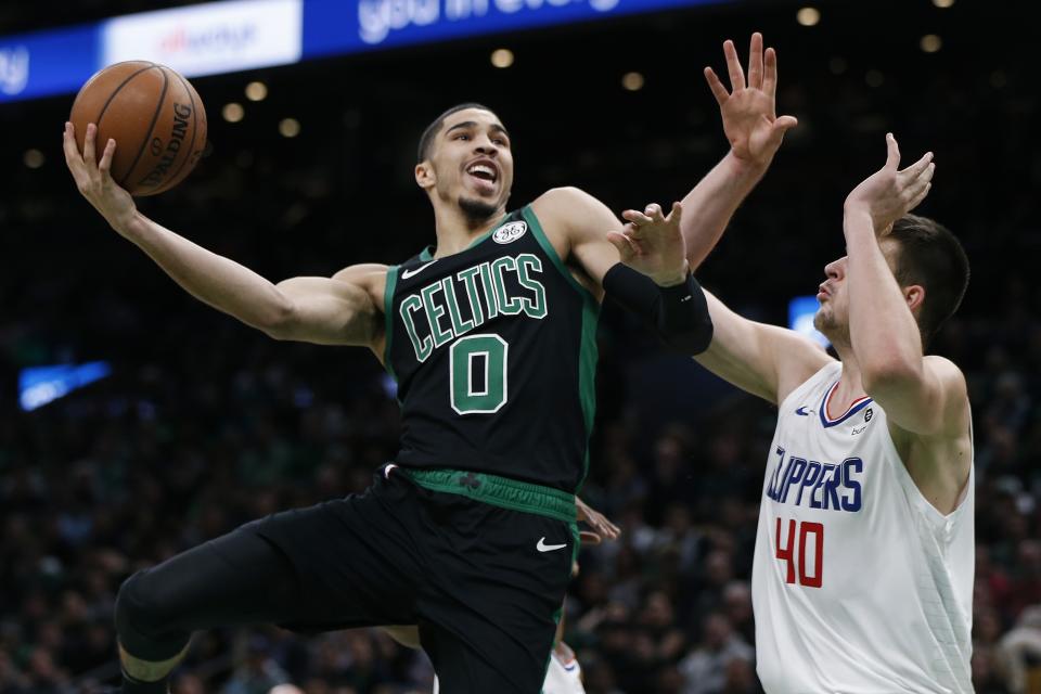 Boston Celtics' Jayson Tatum (0) shoots against Los Angeles Clippers' Ivica Zubac (40) during the first half of an NBA basketball game in Boston, Saturday, Feb. 9, 2019. (AP Photo/Michael Dwyer)