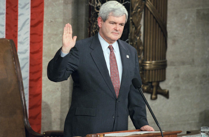 Rep. Newt Gingrich, with pepper-and-salt hair, raises his right hand.