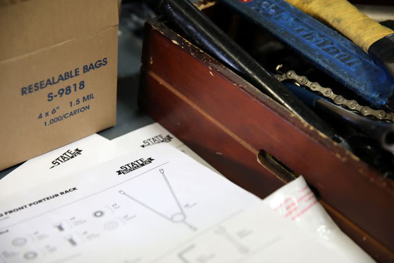 Assembly instructions are seen on a workbench at State Bicycle in Tempe