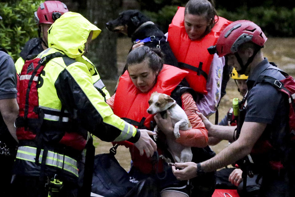 Residents of the Crescent at Lakeshore apartment complex are rescued by Homewood Fire and Rescue as severe weather produced torrential rainfall flooding several apartment buildings Tuesday, May 4, 2021 in Homewood, Ala. (AP Photo/Butch Dill)