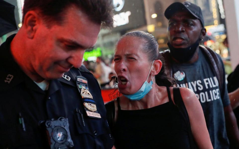 A woman argues with a police officer during a protest in Times Square following the death of black man Daniel Prude, after police put a spit hood over his head during an arrest in Rochester  - Reuters
