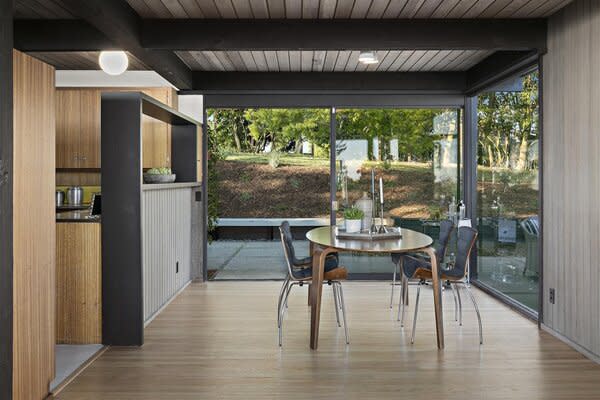Large sliding glass doors allow ample natural light to flood into the dining area and kitchen.
