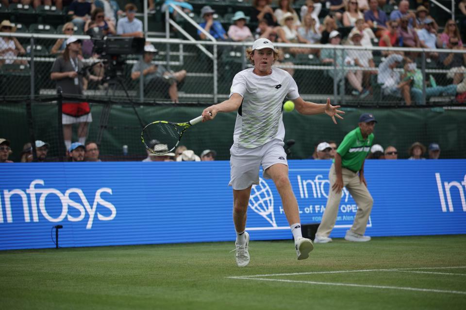 Alex Michelsen hits a forehand return to Mackenzie McDonald during a 6-3, 6-3 victory in the Infosys Hall of Fame Open on Friday.