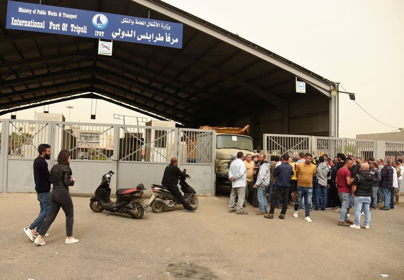 Relatives of people who died when a boat capsized off the Lebanese coast of Tripoli overnight, gather at the entrance of port of Tripoli