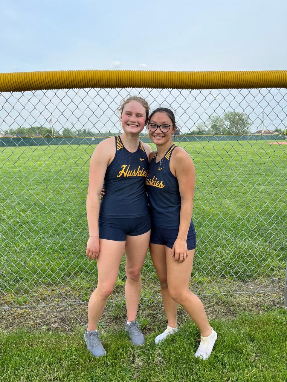 Port Huron Northern's Maggie Monaghan (left) and Jayde Ullenbruch pose for a photo during a Division 1 girls track & field regional at Dakota High School in Macomb on Friday, May 20, 2022. Both qualified for the state meet in the long jump.