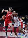 Japan's Moeko Nagaoka (0), left, and United States' A'Ja Wilson (9) fight for a rebound during women's basketball preliminary round game at the 2020 Summer Olympics, Friday, July 30, 2021, in Saitama, Japan. (AP Photo/Charlie Neibergall)