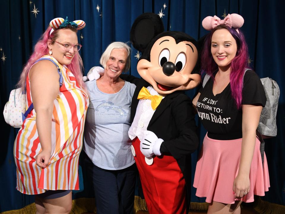 Women posing wit Mickey