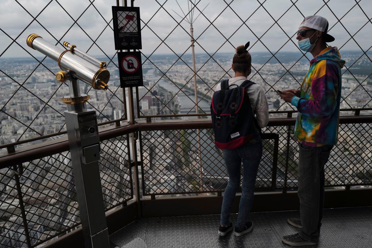Visitors look on from the third level during the opening up of the top floor of the Eiffel Tower on Wednesday, July 15, 2020, in Paris, France. The top floor of Paris' Eiffel Tower reopened today as the 19th century iron monument re-opened its first two floors on June 26 following its longest closure since World War II.