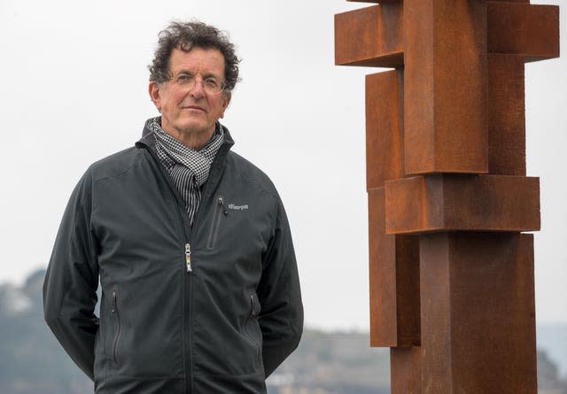 Sculptor Sir Antony Gormley next to an artwork 