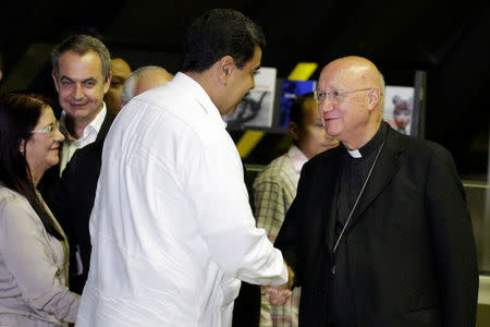 Venezuela's President Nicolas Maduro (C) shakes hands with Claudio Maria Celli (R), Vatican's representative, as he arrives for a political meeting between government and opposition, next to former Spanish prime minister Jose Luis Rodriguez Zapatero (2nd L), and his wife Cilia Flores, in Caracas, Venezuela October 30, 2016. REUTERS/Marco Bello