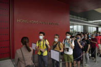 Visitors line up to enter the Hong Kong Palace Museum during the first day open to public in Hong Kong, Sunday, July 3, 2022. It showcases more than 900 Chinese artefacts, loaned from the long-established Palace Museum in Beijing, home to works of art representing thousands of years of Chinese history and culture. (AP Photo/Kin Cheung)