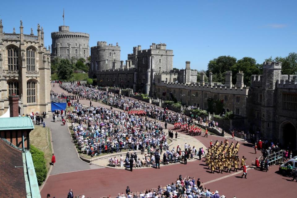 Guards of the Blues and Royals regiment and the military band march around the crowds at Windsor Castle (Getty Images)