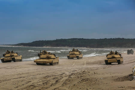 FILE POTO: U.S. Marine Corps M1A1 Abrams tanks patrol the beach during a training mechanized assault for exercise Baltic Operations (BALTOPS) 2018 in Ustka, Poland, June 12, 2018. Picture taken June 12, 2018. U.S. Marine Corps/Staff Sgt. Dengrier M. Baez/Handout via REUTERS.