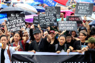 Protesters with placards give a thumbs down sign during a protest denouncing the burial of late dictator Ferdinand Marcos at the Libingan ng mga Bayani (Heroes' cemetery) last week, at Luneta park, metro Manila, Philippines November 25, 2016. REUTERS/Romeo Ranoco