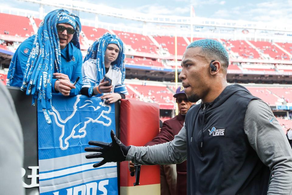 Detroit Lions wide receiver Amon-Ra St. Brown shakes hands with fans during warm up before the NFC championship game against San Francisco 49ers at Levi's Stadium in Santa Clara, Calif. on Sunday, Jan. 28, 2024.