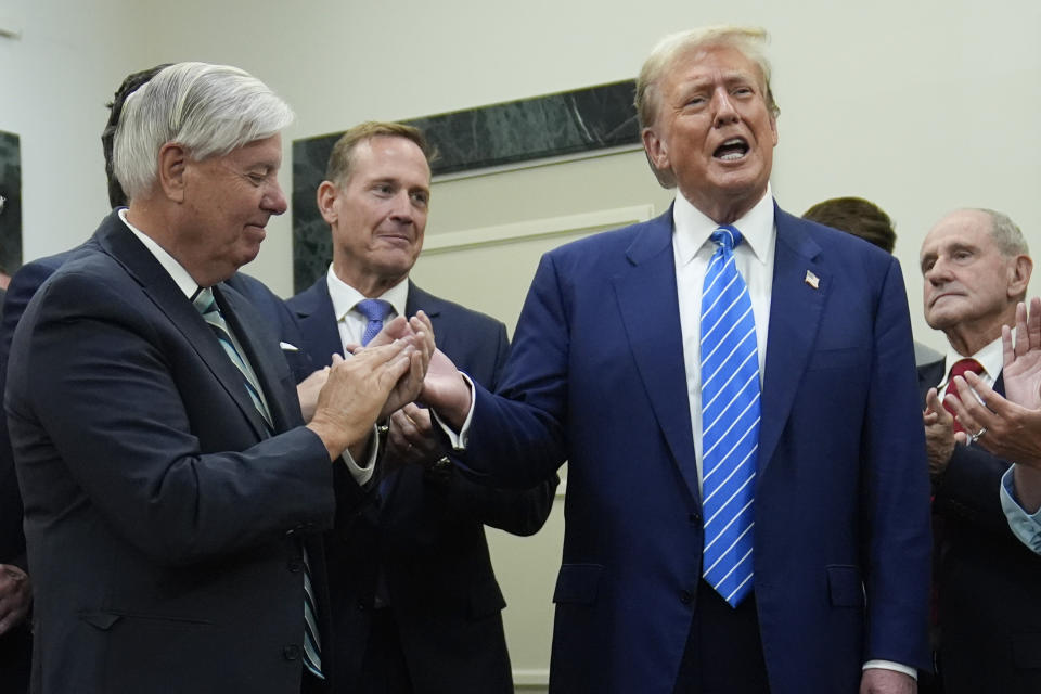 Republican presidential candidate former President Donald Trump arrives to speak with reporters at the National Republican Senatorial Committee, Thursday, June 13, 2024, in Washington. At left is Sen. Lindsey Graham, R-S.C. (AP Photo/Evan Vucci)