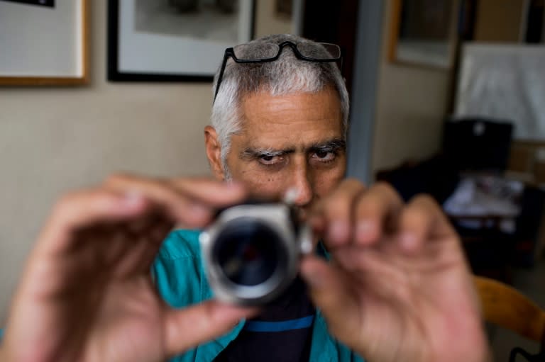 Although working with equipment and techniques that have virtually disappeared, he carries on as if digital photography does not exist