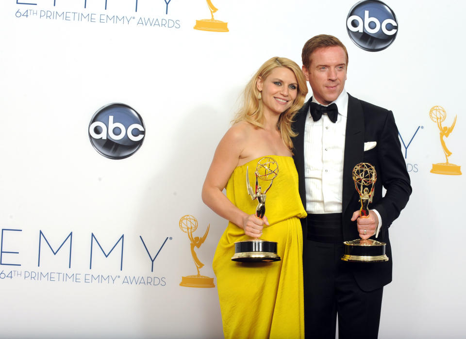 FILE - This Sept. 23, 2012 photo shows actress Claire Danes, winner of the Emmy for Outstanding Lead Actress In A Drama Series for "Homeland" and Actor Damian Lewis, winner Outstanding Lead Actor In A Drama Series for "Homeland" posing backstage at the 64th Primetime Emmy Awards at the Nokia Theatre in Los Angeles. The second season of the Emmy award-winning series premieres Sunday at 10p.m. EST on Showtime. (Photo by Jordan Strauss/Invision/AP)