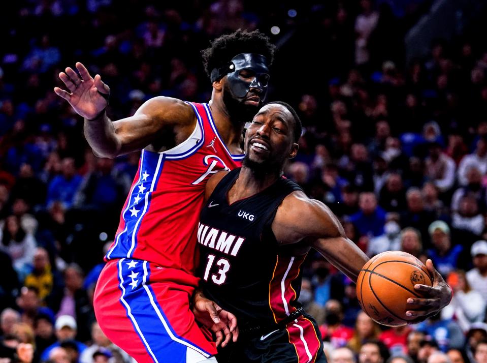 he Miami Heat's Bam Adebayo (13) drives to the net as the Philadelphia 76ers' Joel Embiid defends.