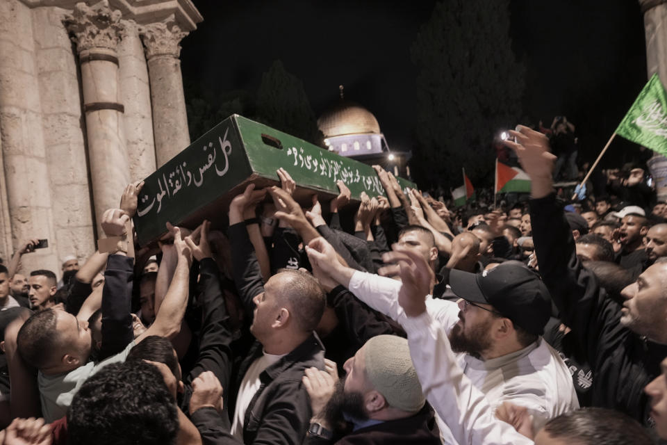 Mourners carry the coffin of Palestinian, Waleed Shareef, 21, during his funeral at the Al Aqsa Mosque compound in Jerusalem's Old City, Monday, May 16, 2022. Shareef died Saturday from a head wound sustained last month after Israeli police fired rubber bullets at stone-throwing Palestinian demonstrators during violence at the Al Aqsa Mosque compound, in Jerusalem's Old City. (AP Photo/Mahmoud Illean)