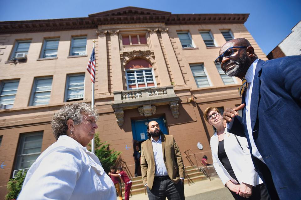 Paterson schools Superintendent Eileen Shafer (left) speaks to Neil Mapp, the district's chief facility and custodial services officer, and state Sen. Nellie Pou during a tour outside Public School 3 on June 8, 2022.