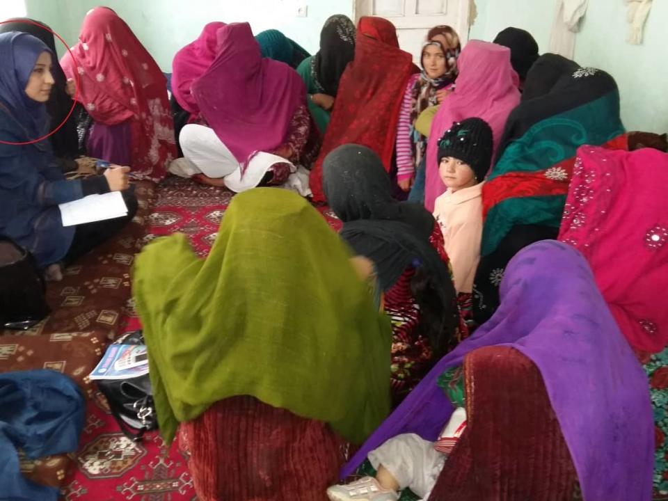 The work that Nelofar Akbari (circled left) did to teach Afghan village women about their legal rights put her on the wrong side of the Taliban. (Nelofar Akbari - image credit)