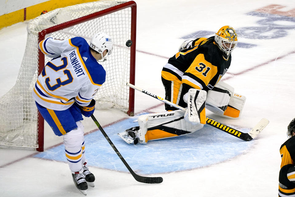 Pittsburgh Penguins goaltender Maxime Lagace (31) blocks a shot by Buffalo Sabres' Sam Reinhart (23) during the third period of an NHL hockey game in Pittsburgh, Saturday, May 8, 2021. The Penguins won 1-0.(AP Photo/Gene J. Puskar)