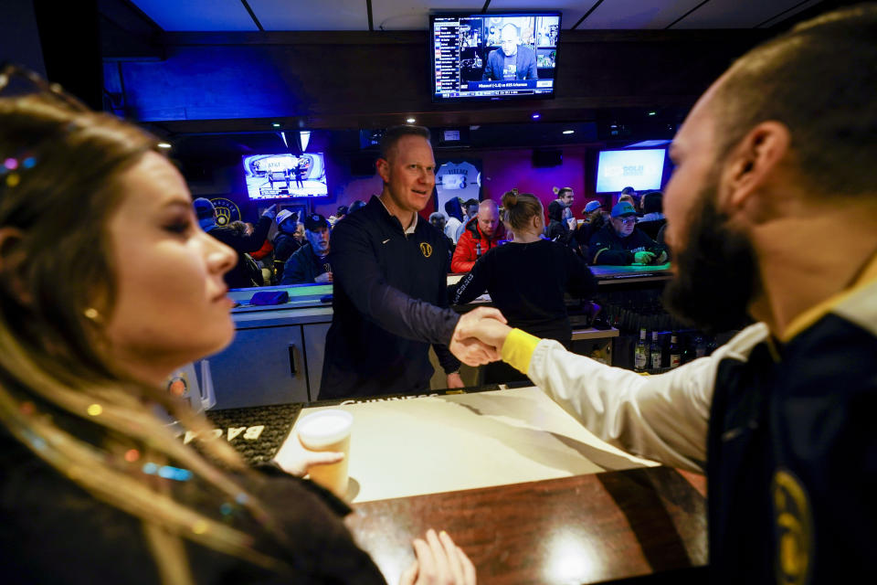 Milwaukee Brewers' General Manager Matt Arnold bartends at a promotional event Wednesday, Jan. 18, 2023, in Milwaukee. (AP Photo/Morry Gash)