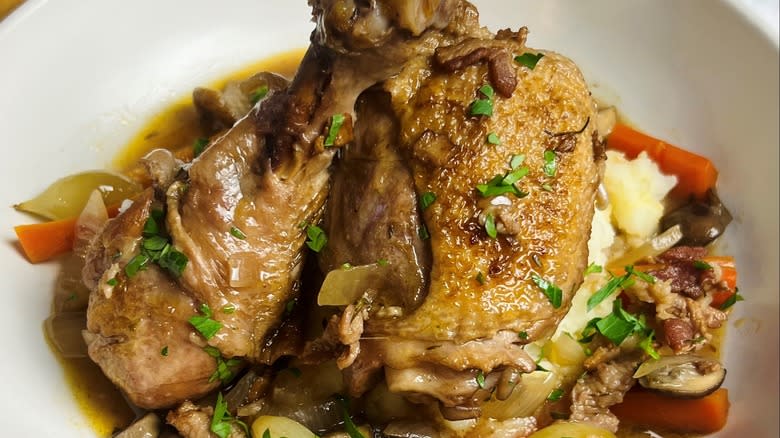 coq au vin with potatoes on plate