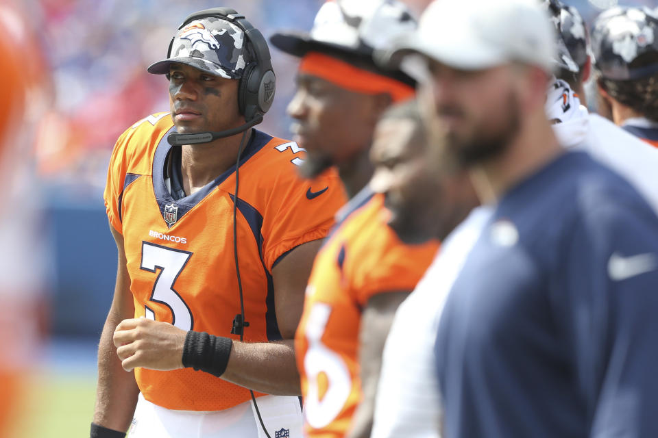 Denver Broncos quarterback Russell Wilson watches from the sidelines during the second half of a preseason NFL football game against the Buffalo Bills, Saturday, Aug. 20, 2022, in Orchard Park, N.Y. (AP Photo/Joshua Bessex)