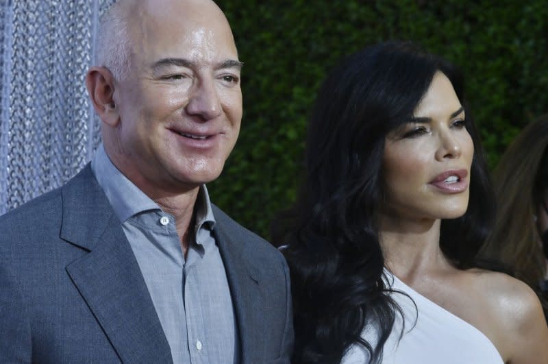 Amazon founder Jeff Bezos (L) announced on Thursday that he and his wife were moving from Seattle to Miami to be closer to his parents, saying, "Lauren (R) and I Iove Miami." File Photo by Jim Ruymen/UPI