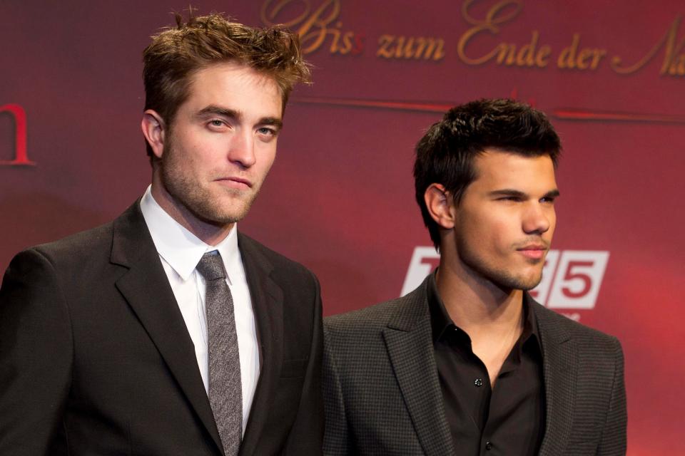 Taylor Lautner, right, opened up about the fan-driven rivalry between him and co-star Robert Pattinson during an appearance on the "Call Her Daddy" podcast.