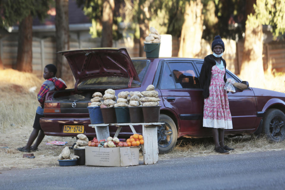 A car displays fruits and vegetables while selling them by the side of a busy road in Harare, Zimbabwe, Tuesday, June 23, 2020. Cars have become mobile markets in Zimbabwe where enterprising residents are selling goods from their vehicles to cope with economic hardships caused by the coronavirus. With their car doors and trunks wide open by the side of busy roads, eager sellers display a colorful array of goods in Harare, the capital. (AP Photo/Tsvangirayi Mukwazhi)