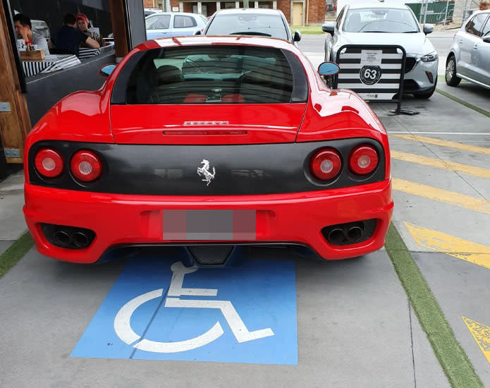 The Ferrari shown parked in a disabled parking spot outside a Brisbane Cafe 63. Source: Reddit