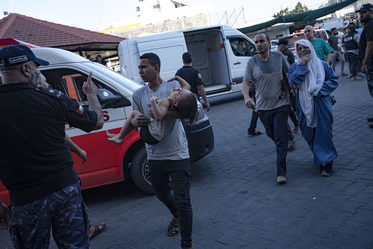 Un palestino lleva a una niña herida al Hospital Shifa, el martes 10 de octubre de 2023, en Ciudad de Gaza. (AP Foto/Fatima Shbair, Archivo)