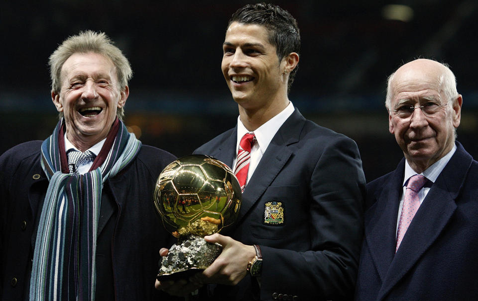 FILE - Manchester United's Cristiano Ronaldo, center, holds the Ballon d'Or trophy, as former Manchester United players Denis Law, left, and Bobby Charlton, right, look on, at Old Trafford Stadium, Manchester, England, Dec. 10, 2008. Bobby Charlton, an English soccer icon who survived a plane crash that decimated a Manchester United team destined for greatness to become the heartbeat of his country's 1966 World Cup-winning team, has died. He was 86. A statement from Charlton's family, released by United, said he died Saturday Oct. 21, 2023 surrounded by his family. (AP Photo/Jon Super, File)