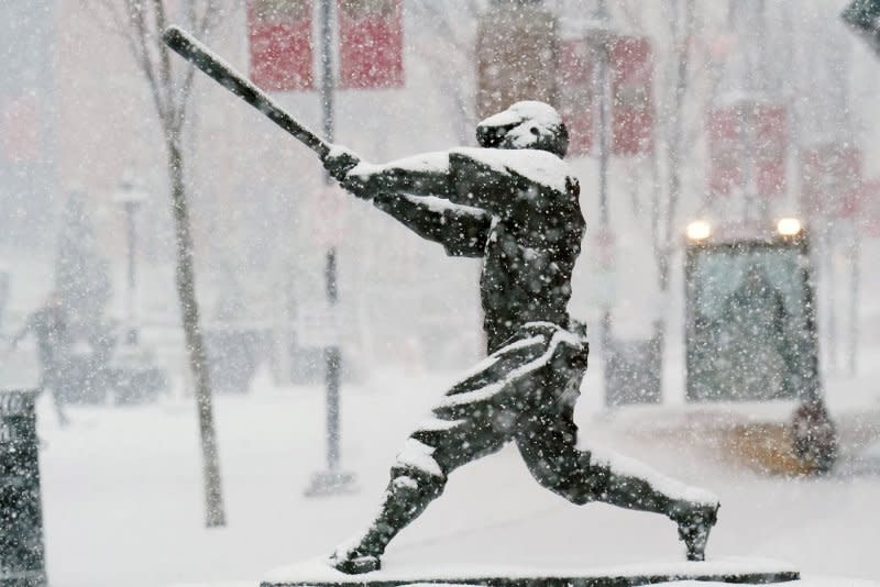 As heavy snow falls on the statues outside of Busch Stadium, a snow sweeper attempts to clear the sidewalks in St. Louis on Friday, February 16, 2024. Snow begin to fall during the morning rush hour, dumping up to six inches of snow on the area until stopping in the late afternoon. Photo by Bill Greenblatt/UPI