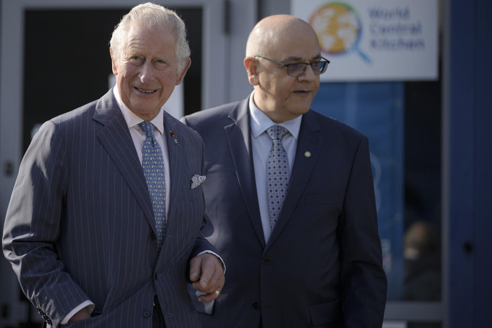 Britain's Prince Charles, left, listens to the head of Romania's Department for Emergency Situations (DSU) Raed Arafat, right, after a visit at a center for refugees fleeing the war in neighboring Ukraine, at the Romexpo convention center, in Bucharest, Romania, Wednesday, May 25, 2022. (AP Photo/Vadim Ghirda)