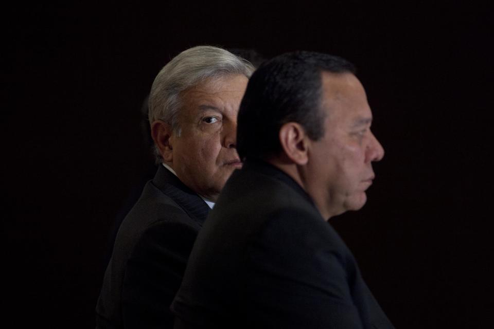 Andres Manuel Lopez Obrador, presidential candidate for the Democratic Revolution Party (PRD), left, attends a news conference in Mexico City, Friday, July 20, 2012. Lopez Obrador claims that winning candidate of Mexico’s presidential election, Enrique Pena Nieto engaged in overspending and vote buying. (AP Photo/Alexandre Meneghini)