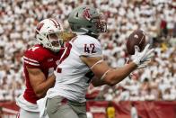 Washington State's Billy Riviere III (42) catches a pass in front of Wisconsin's Preston Zachman (14) during the first half of an NCAA college football game Saturday, Sept. 10, 2022, in Madison, Wis. (AP Photo/Morry Gash)