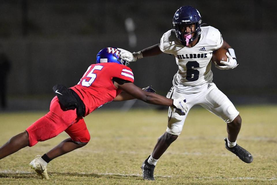 Millbrook running back Xavier Pugh (6) stiff-arms Wake Forest’s Andre Evans (15) during the second half. The Wake Forest Cougars and the Millbrook Wildcats met in a football game in Wake Forest, N.C. on October 28, 2022.