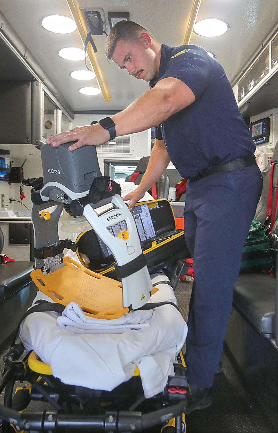 Cuyahoga Falls firefighter Travis Moore performs the daily check on a CPR in an ambulance at Station No. 3.