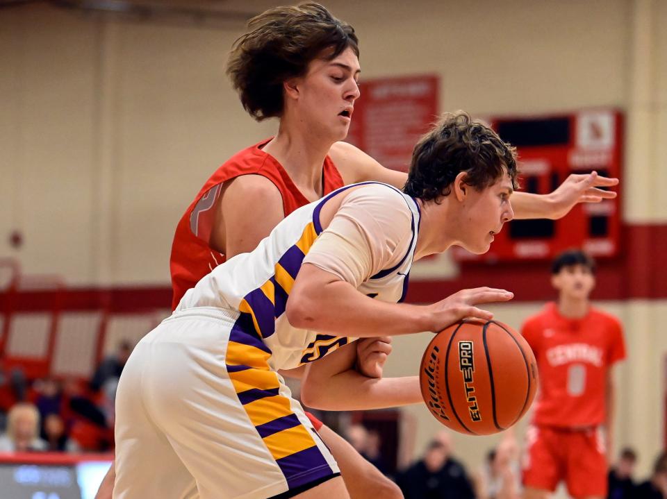 Watertown's Marcus Rabine (15) dribbles past the defense of Rapid City Central's Cooper Totten (34) during their high school boys basketball game on Saturday, Jan. 21, 2023 at Rapid City.